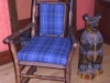 New leather and a thick woven plaid make a bold statement against the glow of the wood frame