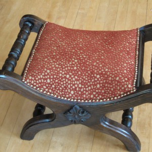 With a fun flocked fabric this little stool/seat is used all over the room