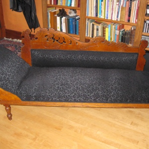With new stuffing and a sophisticated black damask fabric, this versatile antique is ready for anything